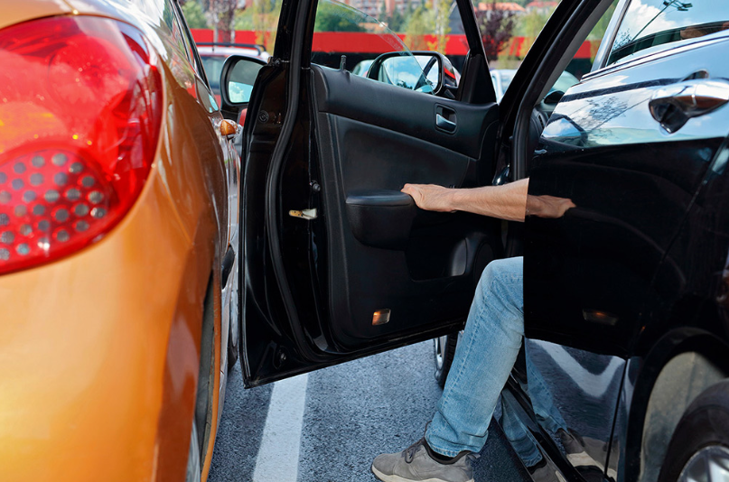 Close-up of a door ding or minor dent on a vehicle