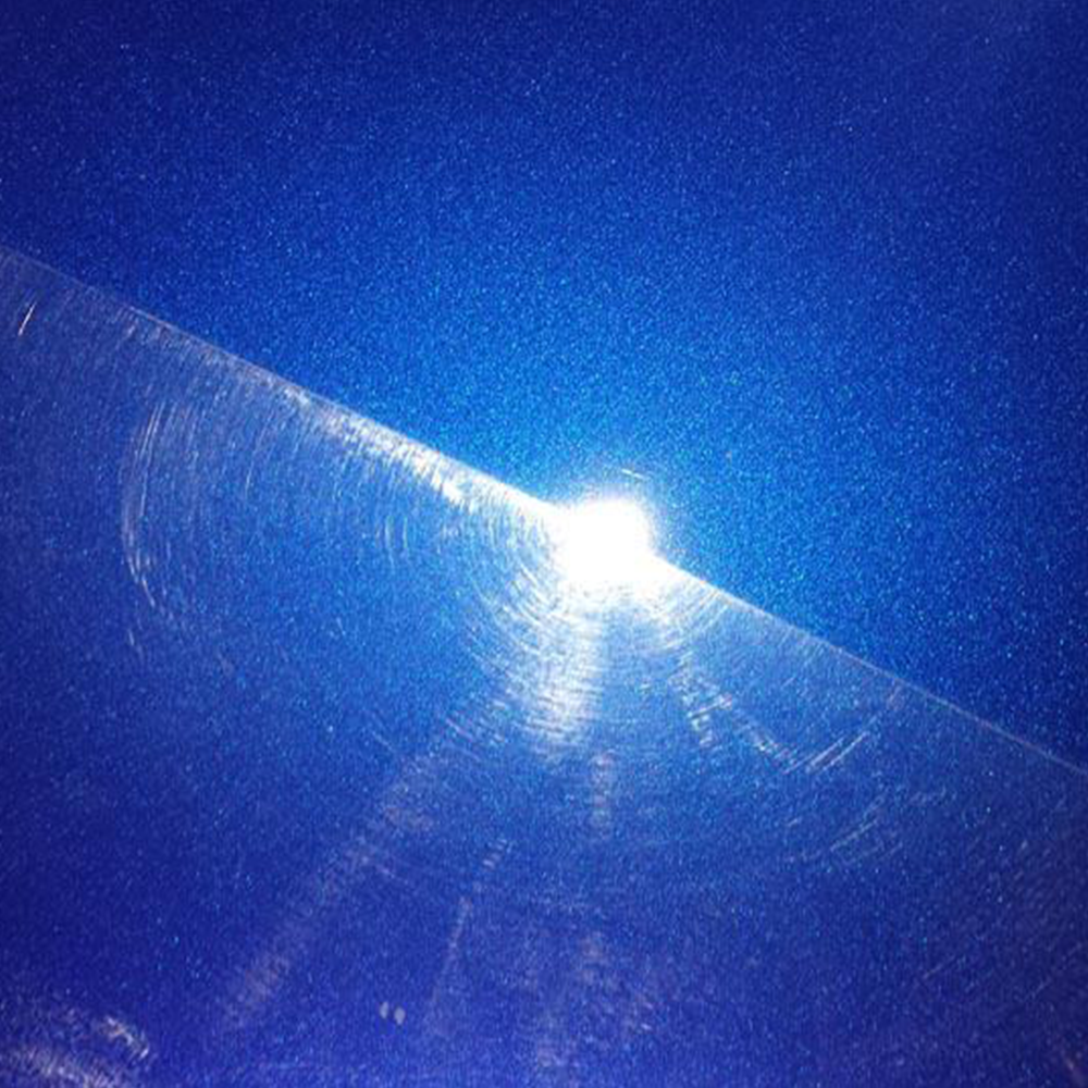 Close-up of paint swirl marks on a car's surface